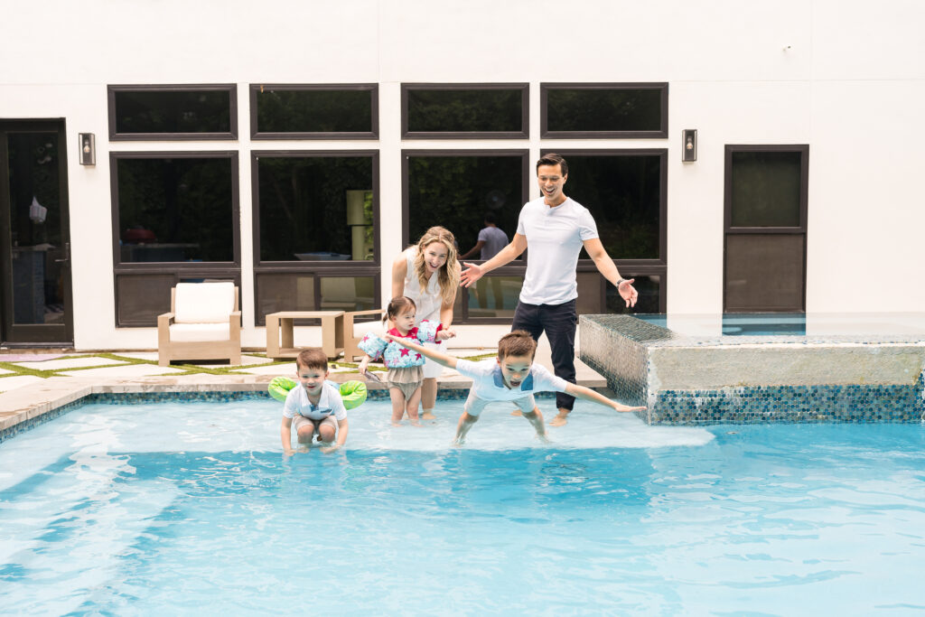 A family having fun doing photos in their pool during the best time of year for family photos
