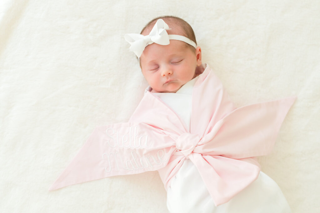 Sleeping newborn wrapped in a cozy swaddle during an in-home newborn photography session in Austin, TX.