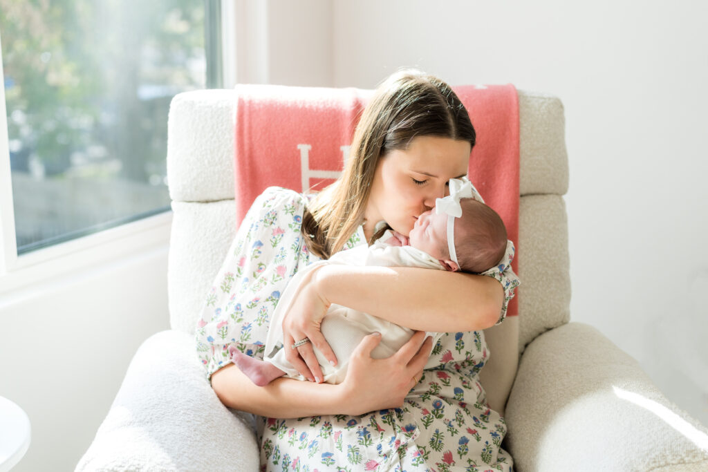 Mother kisses baby in nursery for their Lifestyle Newborn Session in Austin, TX