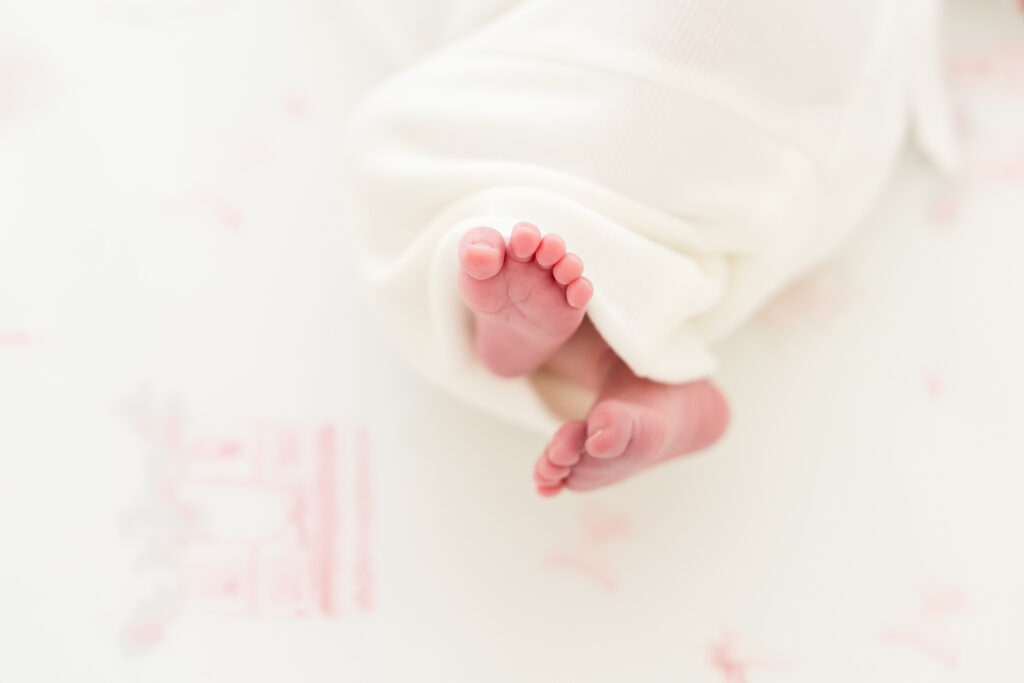 Close-up of a newborn’s tiny fingers and toes, photographed in a bright and airy Austin home