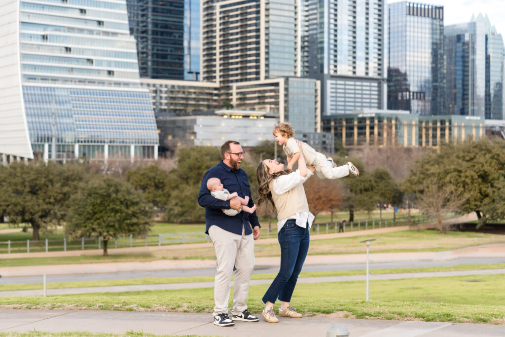 A family with two young children enjoying their photos taken with Alissa Cordoba Photography at Zilker Park.