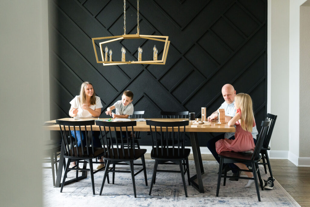 A family enjoying games together during their relaxed and stress free family photography session in their home.