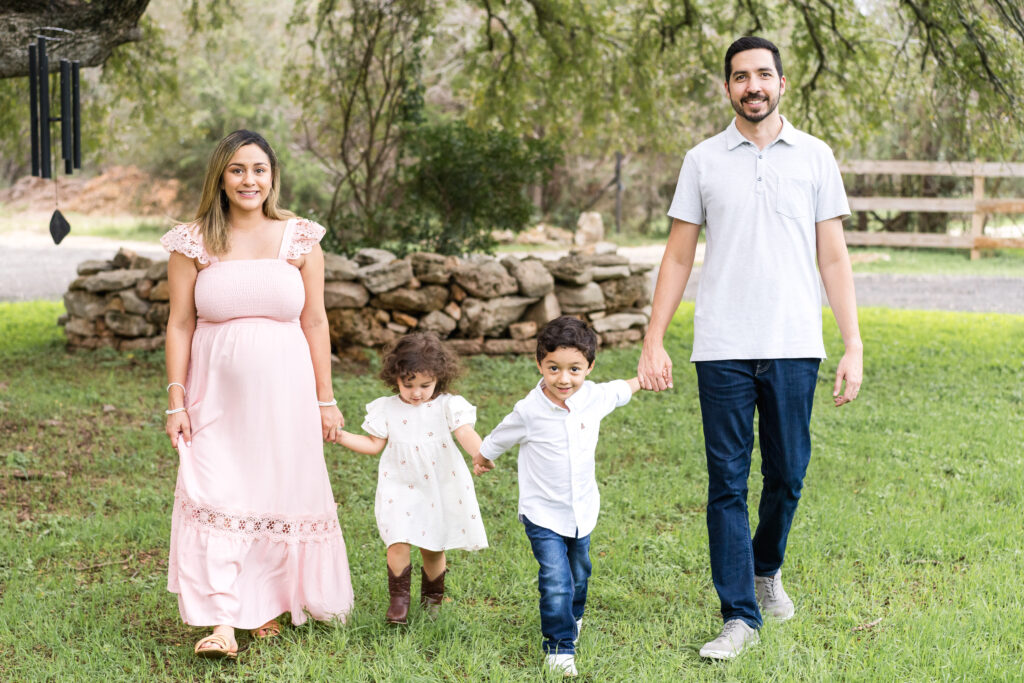 Family of four during relaxed family photo session outdoors in Austin, Texas
