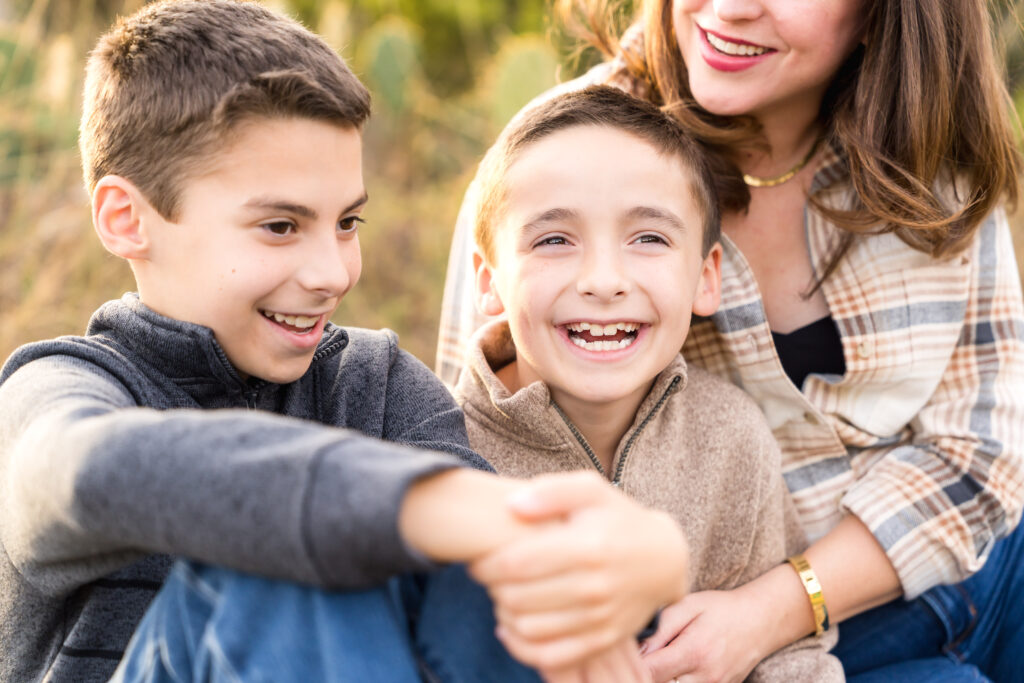 Brothers smiling during their family photos in Austin.

