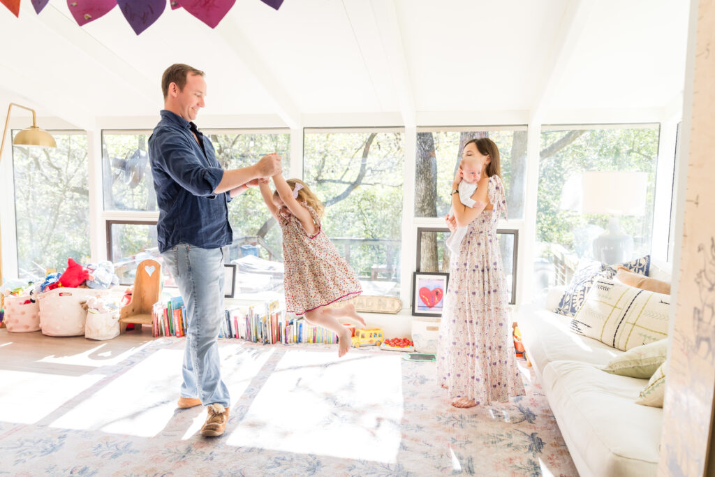 A family having fun in their playroom as their Austin family photographer takes their photo.