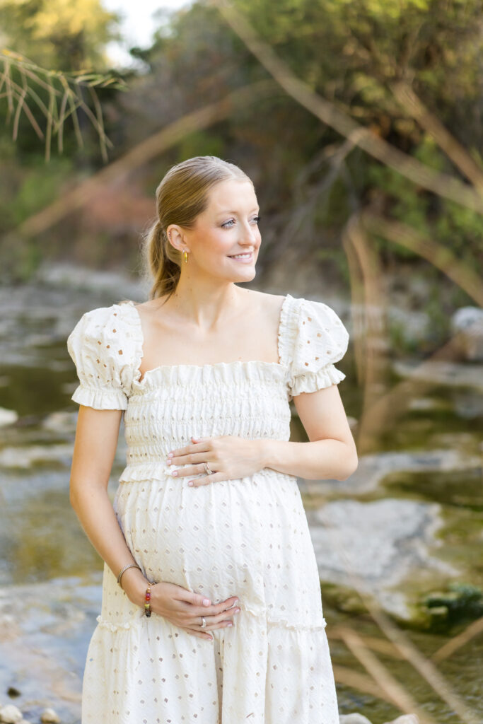 A woman wearing a flowy dress for her maternity photo session with Alissa Cordoba Photography.