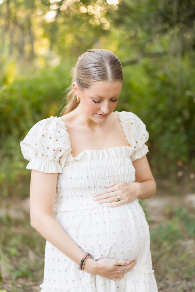 A woman wearing a flowy dress for her maternity photo session with Alissa Cordoba Photography.