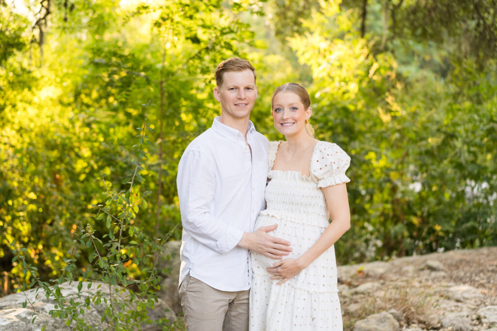 A family doing a maternity photo session at Pease Park in Austin.