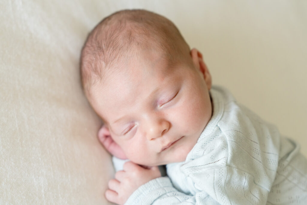 Lifestyle newborn photography captures a sweet newborn sleeping.