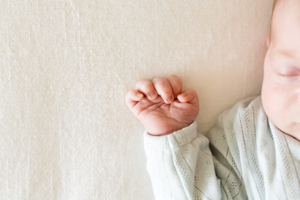 Lifestyle newborn photography captures a sweet newborn sleeping.