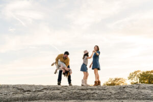 A family of four walking at McKinney Falls during their photo session.