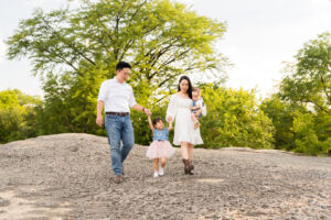 A family of four walking at McKinney Falls during their photo session.