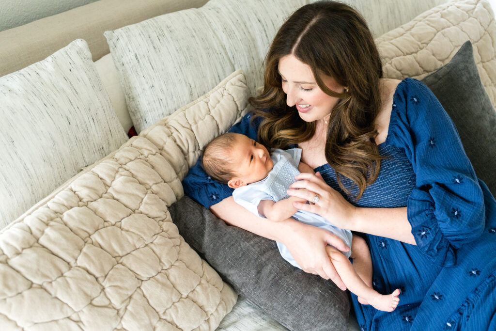 Mother holding newborn during in-home session in Austin
